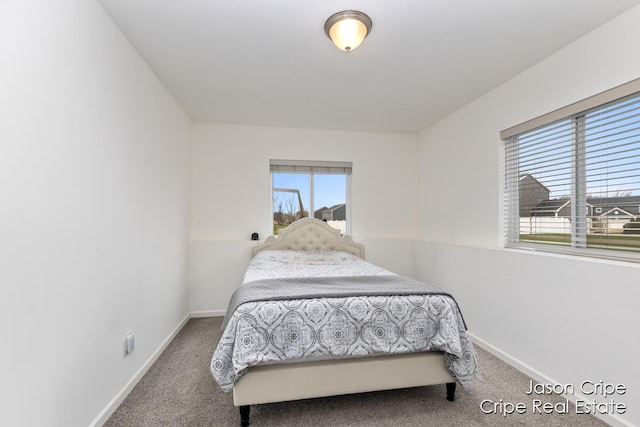 bedroom with carpet floors and baseboards