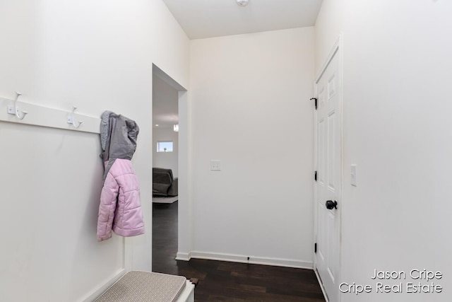 interior space with wood finished floors and baseboards