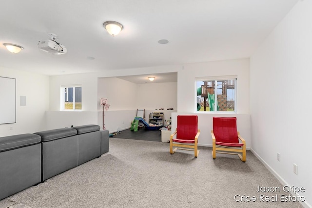 carpeted living room with a wealth of natural light and baseboards