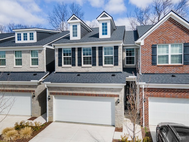 multi unit property with an attached garage, a shingled roof, driveway, and stone siding