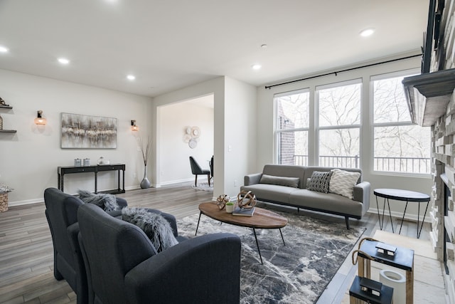 living area with wood finished floors, baseboards, and recessed lighting