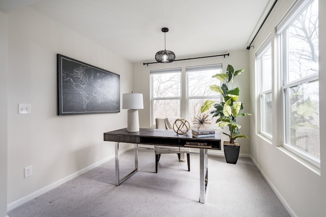 carpeted home office featuring a wealth of natural light and baseboards