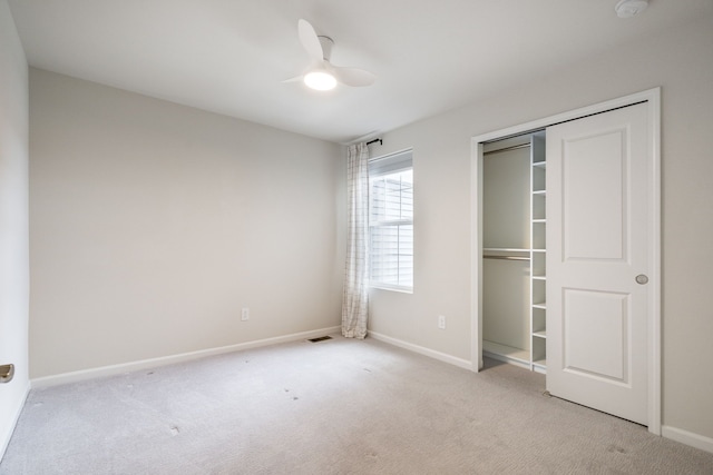 unfurnished bedroom with baseboards, a ceiling fan, carpet flooring, and a closet