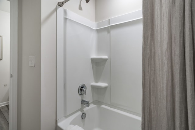bathroom with shower / bathtub combination with curtain