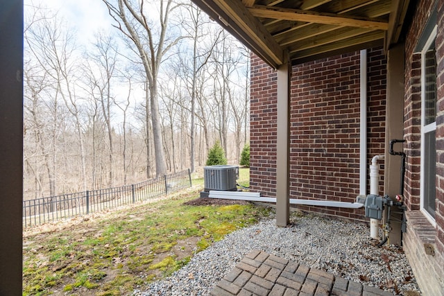 view of yard featuring central air condition unit and fence
