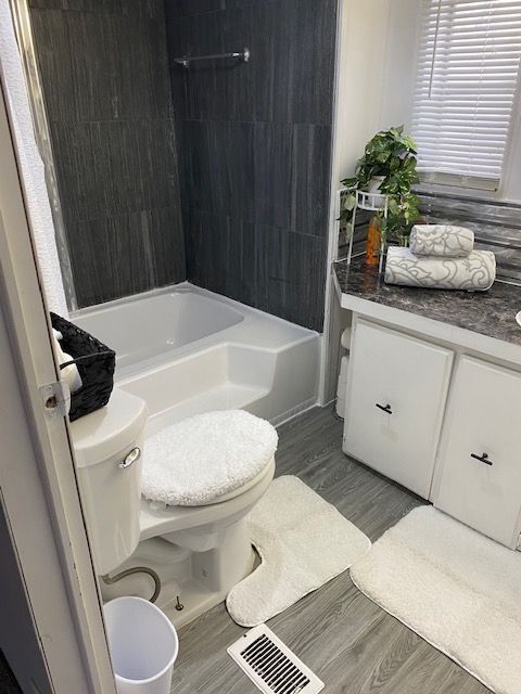 50594 Oregon Ave, Novi, MI 48374 - bathroom with toilet, shower / washtub combination, wood finished floors, and vanity