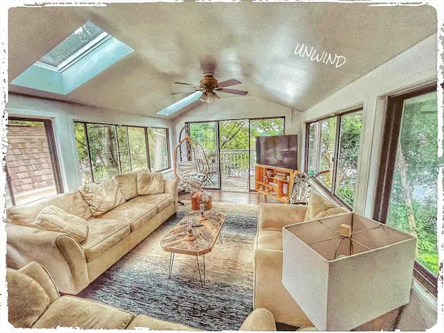 520 Bellevue Ave, Lake Orion, MI 48362 - living room with a ceiling fan, a wealth of natural light, and vaulted ceiling with skylight
