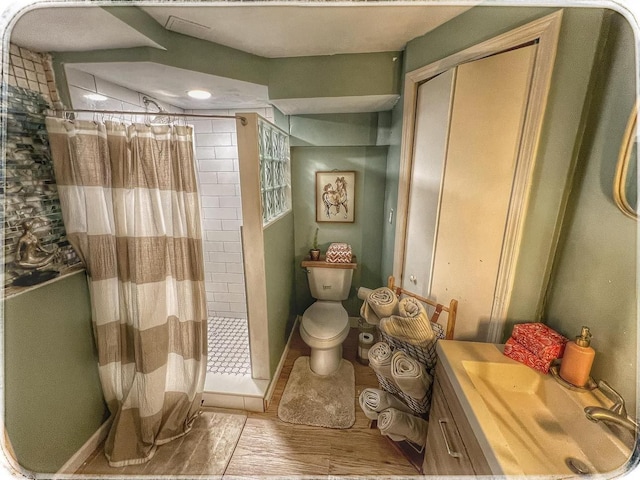 520 Bellevue Ave, Lake Orion, MI 48362 - full bath with toilet, a stall shower, baseboards, wood finished floors, and vanity