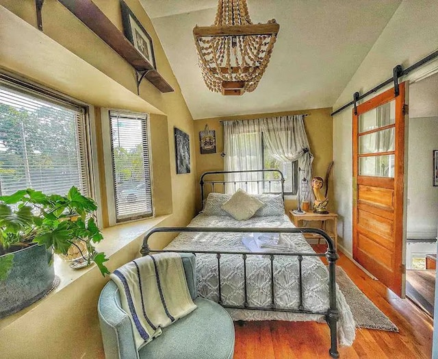 520 Bellevue Ave, Lake Orion, MI 48362 - bedroom featuring a barn door, vaulted ceiling, and multiple windows