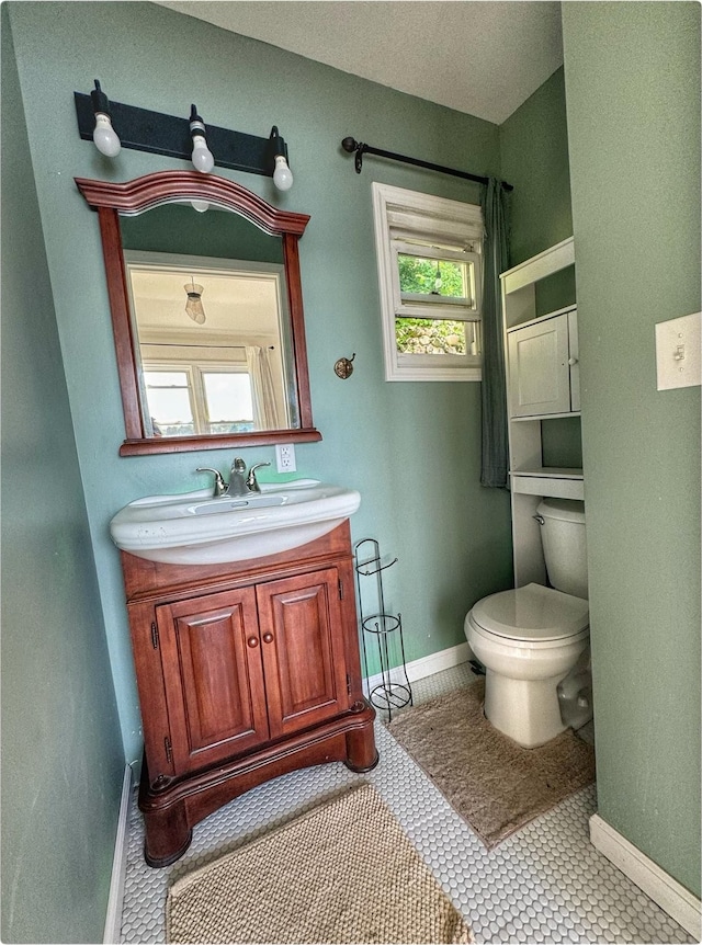 520 Bellevue Ave, Lake Orion, MI 48362 - bathroom with baseboards, toilet, and vanity