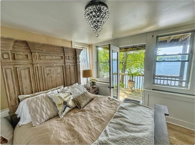 520 Bellevue Ave, Lake Orion, MI 48362 - bedroom featuring baseboards, access to outside, and wood finished floors