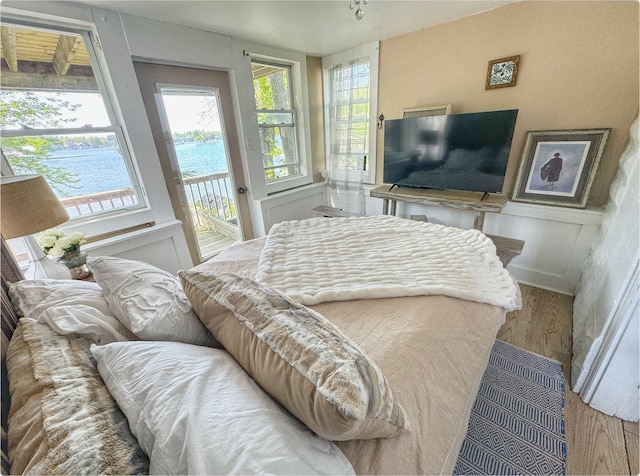 520 Bellevue Ave, Lake Orion, MI 48362 - bedroom with wood finished floors, access to exterior, and a water view