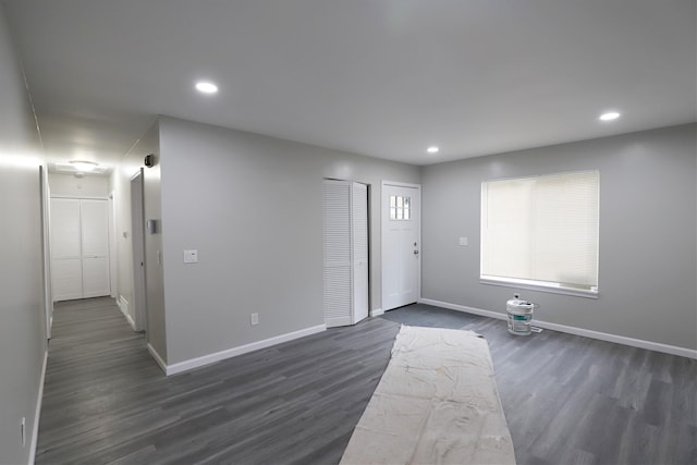 unfurnished living room featuring dark wood finished floors, baseboards, and recessed lighting