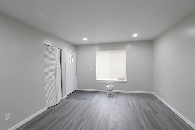 empty room with recessed lighting, baseboards, and dark wood-style flooring