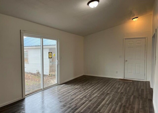 327 E Main St, Vermontville, MI 49096 - spare room featuring baseboards and dark wood-style flooring