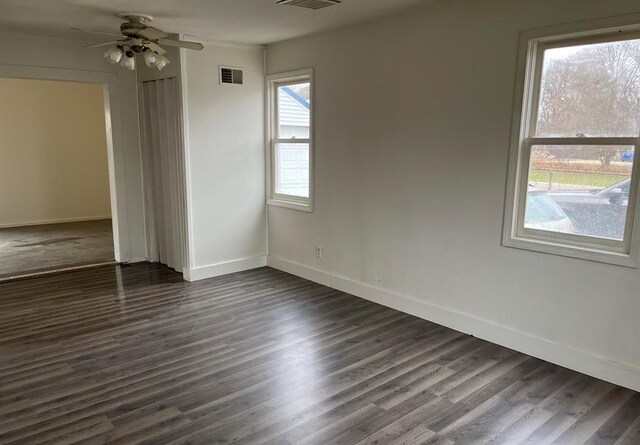 327 E Main St, Vermontville, MI 49096 - spare room featuring baseboards, visible vents, a ceiling fan, and dark wood-style floors