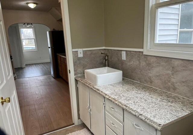 327 E Main St, Vermontville, MI 49096 - bathroom featuring wood finished floors and vanity
