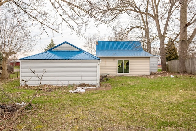 327 E Main St, Vermontville, MI 49096 - back of house with a lawn, metal roof, and fence