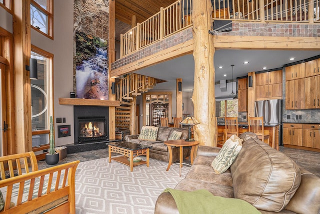 living room featuring recessed lighting, a towering ceiling, and a large fireplace