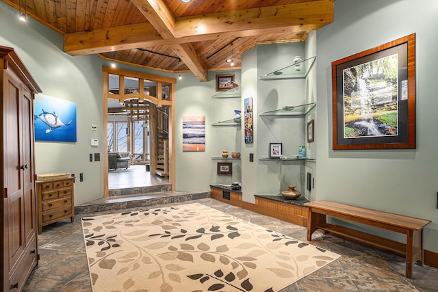 corridor with recessed lighting, stone tile flooring, beam ceiling, and wooden ceiling