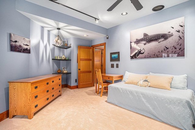 carpeted bedroom featuring baseboards and a ceiling fan