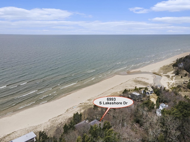 birds eye view of property with a beach view and a water view