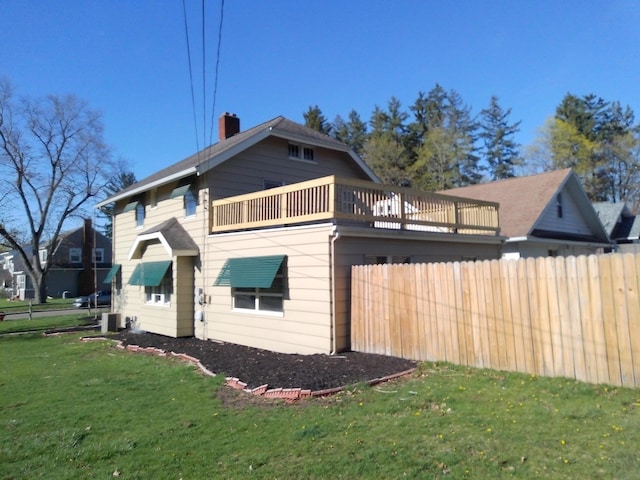 802 Oakridge Dr, Jackson, MI 49203 - view of home's exterior featuring central AC unit and a chimney