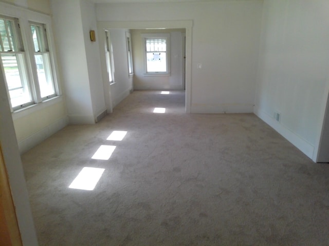 802 Oakridge Dr, Jackson, MI 49203 - empty room with light colored carpet, plenty of natural light, and baseboards