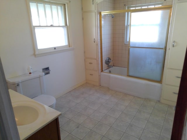 802 Oakridge Dr, Jackson, MI 49203 - bathroom with bath / shower combo with glass door, vanity, toilet, and tile patterned flooring