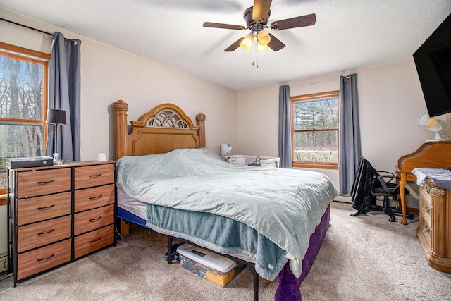 bedroom featuring ceiling fan and light carpet