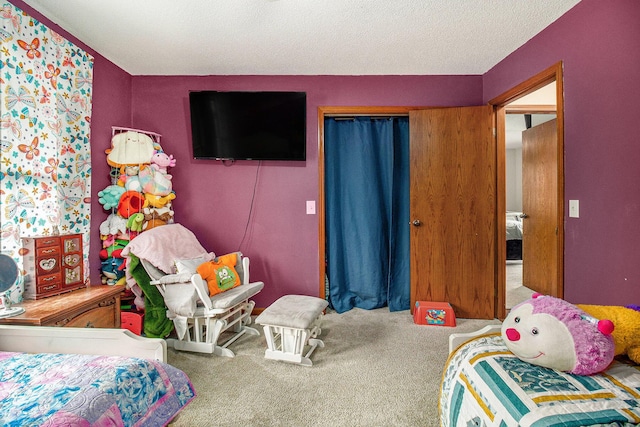 bedroom featuring a textured ceiling, a closet, and carpet floors