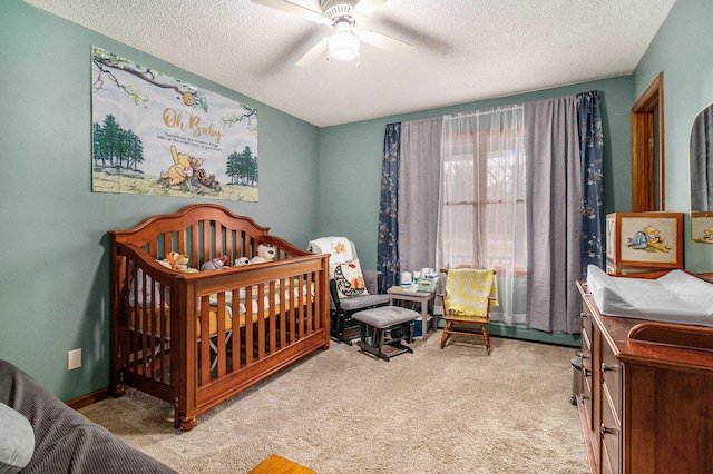 bedroom featuring carpet, a textured ceiling, and ceiling fan