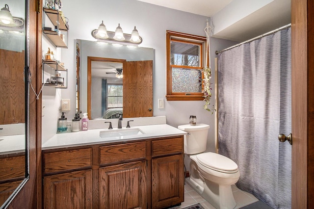 bathroom with vanity, ensuite bath, a ceiling fan, tile patterned flooring, and toilet