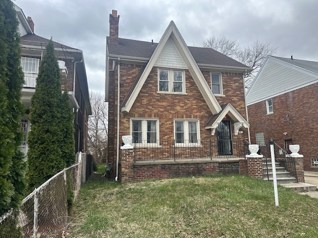 371 Piper Blvd, Detroit, MI 48215 - exterior space with brick siding, a shingled roof, a front yard, and fence