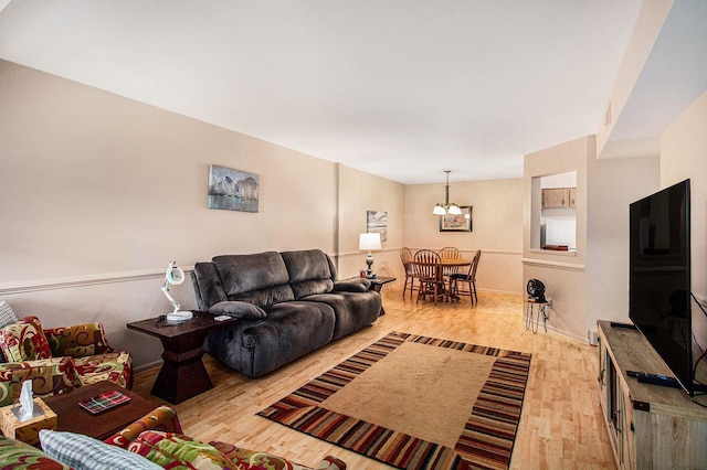 61043 Greenwood Dr # 167, South Lyon, MI 48178 - living room with light wood-type flooring and a chandelier