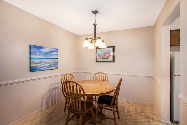 61043 Greenwood Dr # 167, South Lyon, MI 48178 - dining room with a chandelier and wood finished floors