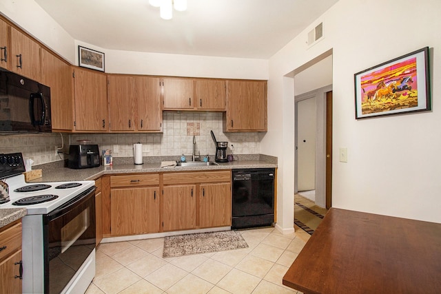 61043 Greenwood Dr # 167, South Lyon, MI 48178 - kitchen featuring black appliances, backsplash, and light tile patterned flooring