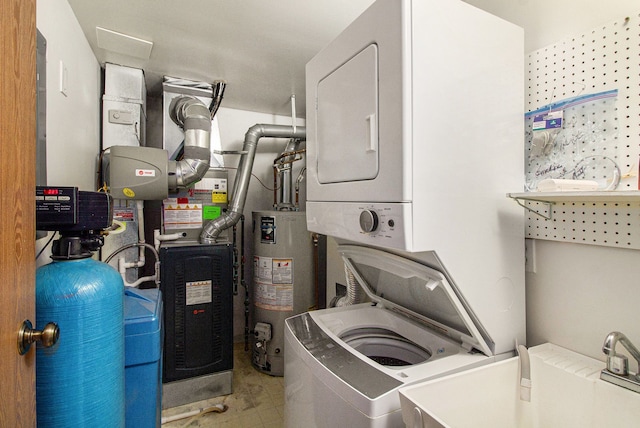 61043 Greenwood Dr # 167, South Lyon, MI 48178 - laundry room featuring stacked washer / drying machine and water heater