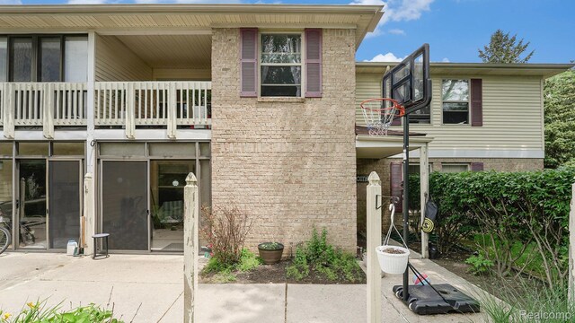61043 Greenwood Dr # 167, South Lyon, MI 48178 - rear view of property with a balcony and brick siding