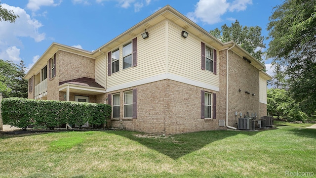 61043 Greenwood Dr # 167, South Lyon, MI 48178 - view of property exterior with a lawn and brick siding