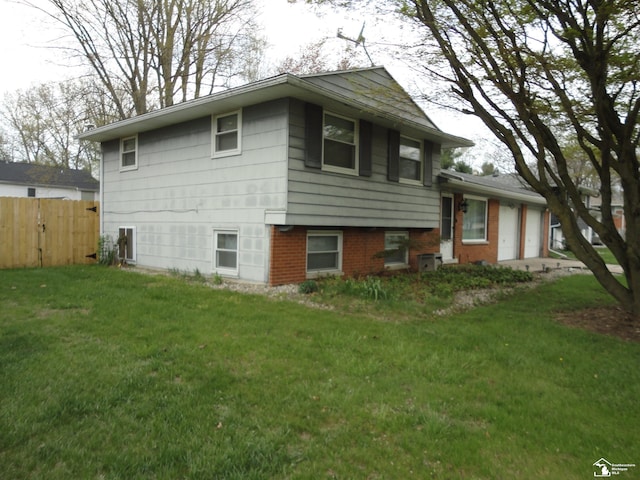 7303 Cranbrook Dr, Lambertville, MI 48144 - view of front of property with fence, an attached garage, and a front lawn