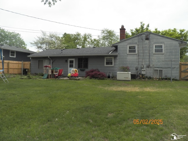 7303 Cranbrook Dr, Lambertville, MI 48144 - rear view of property with a lawn, roof with shingles, fence, and a chimney