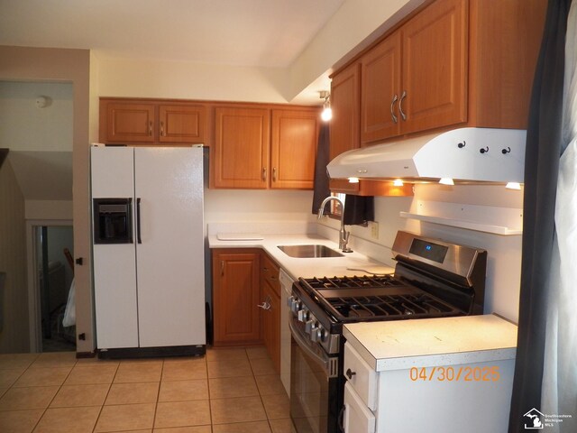 7303 Cranbrook Dr, Lambertville, MI 48144 - kitchen with a sink, light countertops, stainless steel gas range, white fridge with ice dispenser, and under cabinet range hood