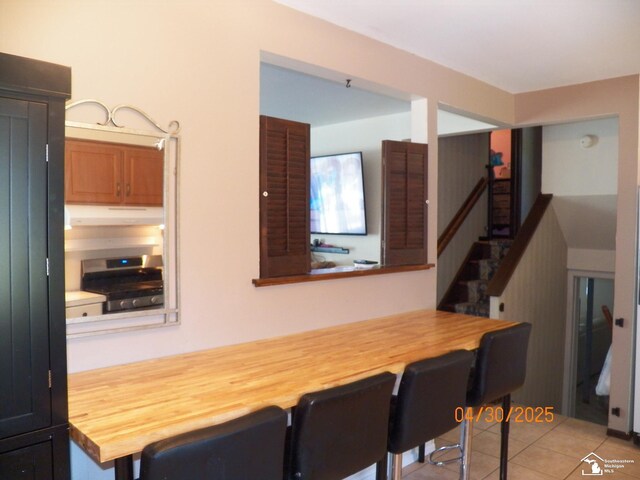7303 Cranbrook Dr, Lambertville, MI 48144 - dining area with light tile patterned floors and stairs