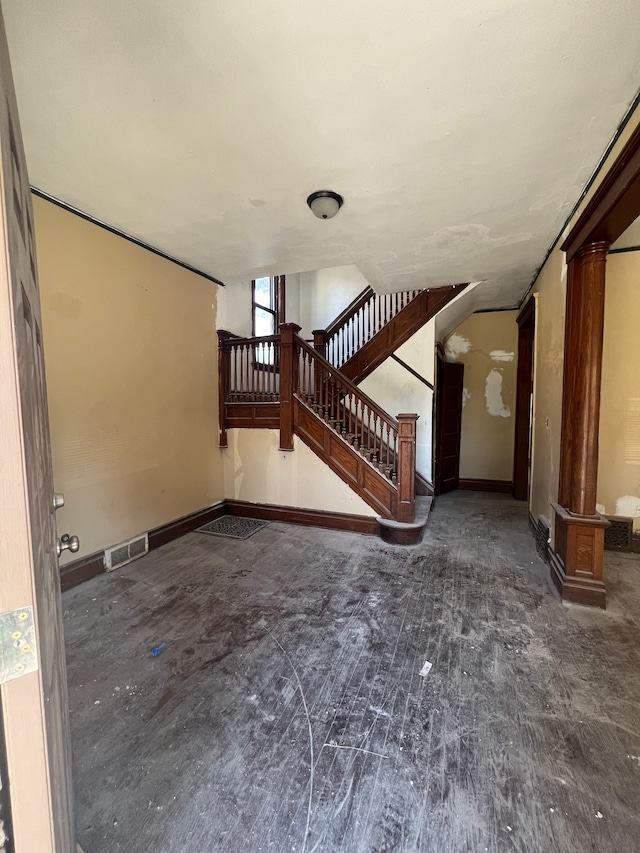 207 Connecticut St, Highland Park, MI 48203 - unfurnished living room featuring baseboards, stairs, visible vents, and ornate columns