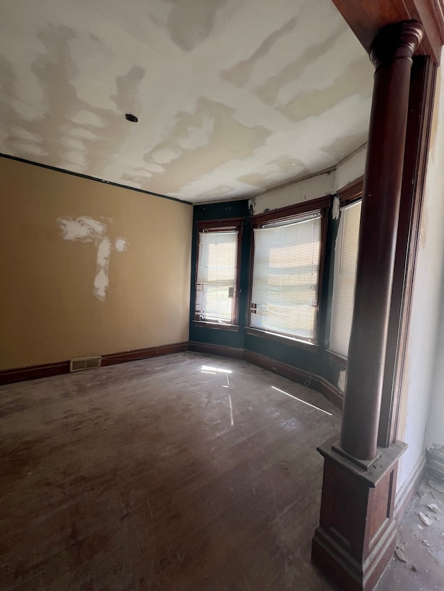 207 Connecticut St, Highland Park, MI 48203 - unfurnished room with wood finished floors, baseboards, decorative columns, and visible vents