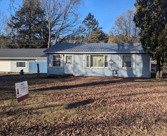 single story home with metal roof
