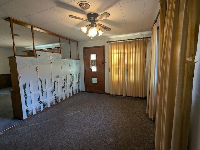 interior space with a ceiling fan and visible vents