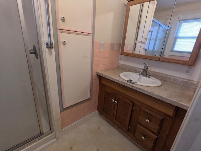 full bathroom featuring vanity and a stall shower