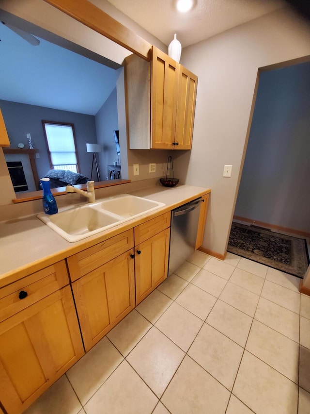 2109 Appleway Dr, Jackson, MI 49203 - kitchen featuring stainless steel dishwasher, a sink, light countertops, light brown cabinetry, and vaulted ceiling